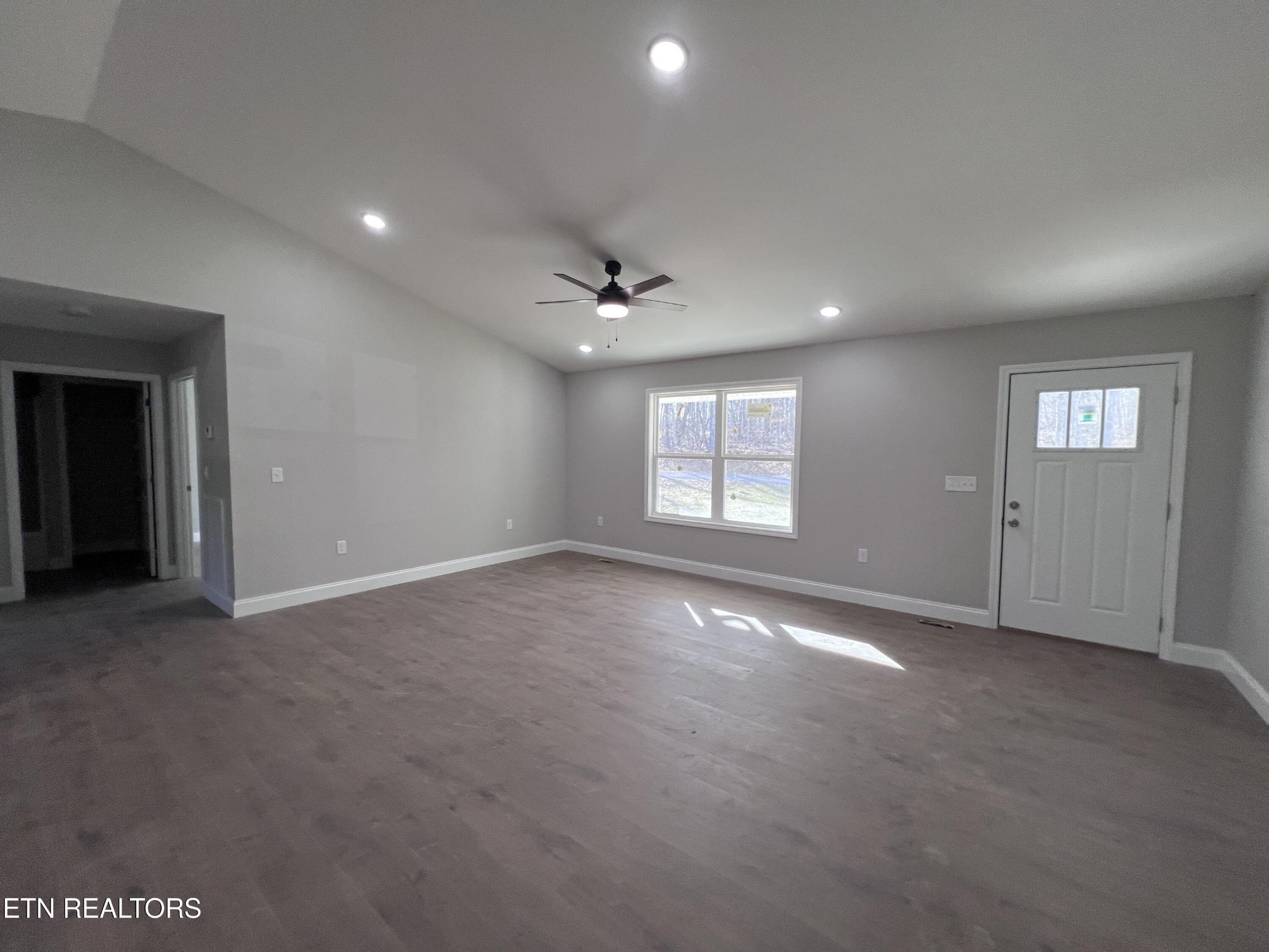133 Jay Loop Jamestown, TN 38556 - Photo 6 of 33 an empty room with windows and ceiling fan