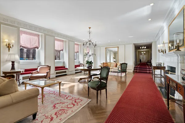 a living room with furniture wooden floor and a chandelier