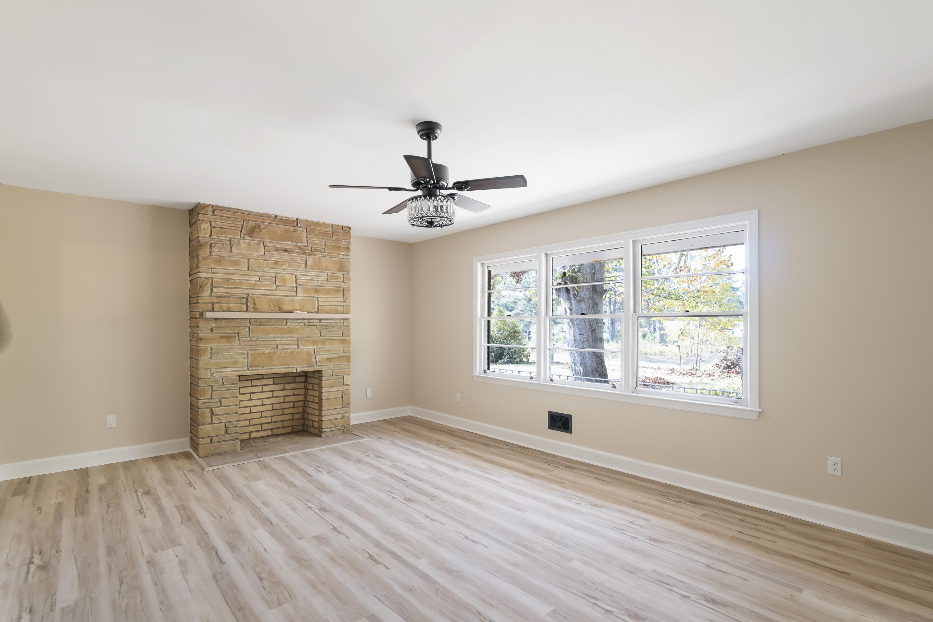 39 Gantt Street Wagener, SC 29164 - Photo 3 of 30 a view of an empty room with a window and wooden floor