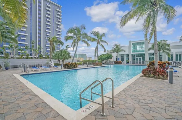 a view of swimming pool with outdoor seating and plants