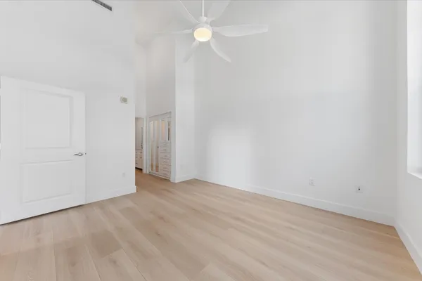 a view of an empty room with a fan