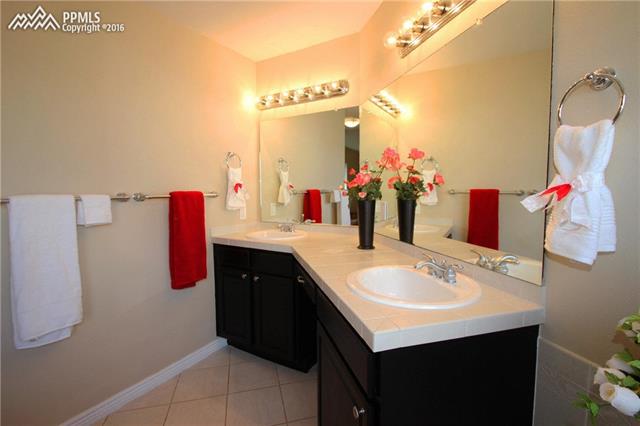 5224 Rondo Way Colorado Springs, CO 80911 - Photo 16 of 36 Double vanity in master bath with seating area.