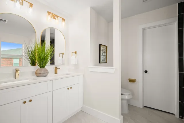 a bathroom with a toilet sink and mirror