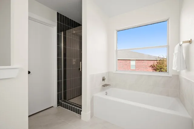 a bathroom with a bathtub and a shower