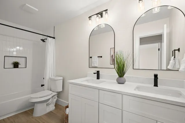 a bathroom with a toilet sink and mirror