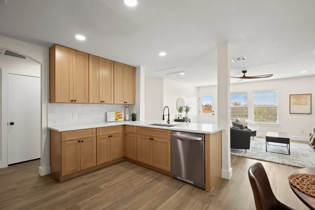 a kitchen with a sink cabinets and wooden floor