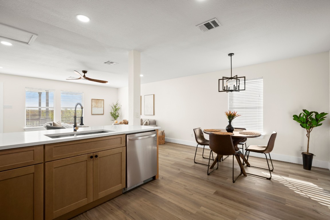 13625 Coomer Path Pflugerville, TX 78660 - Photo 4 of 22 a kitchen with a table and chairs in it