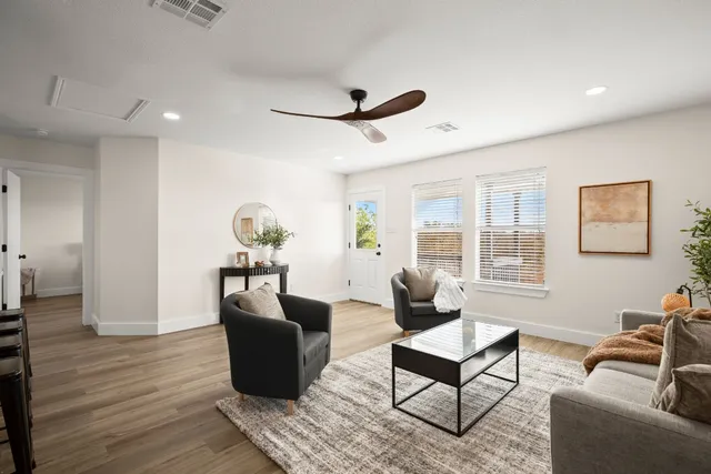 a living room with furniture rug and window