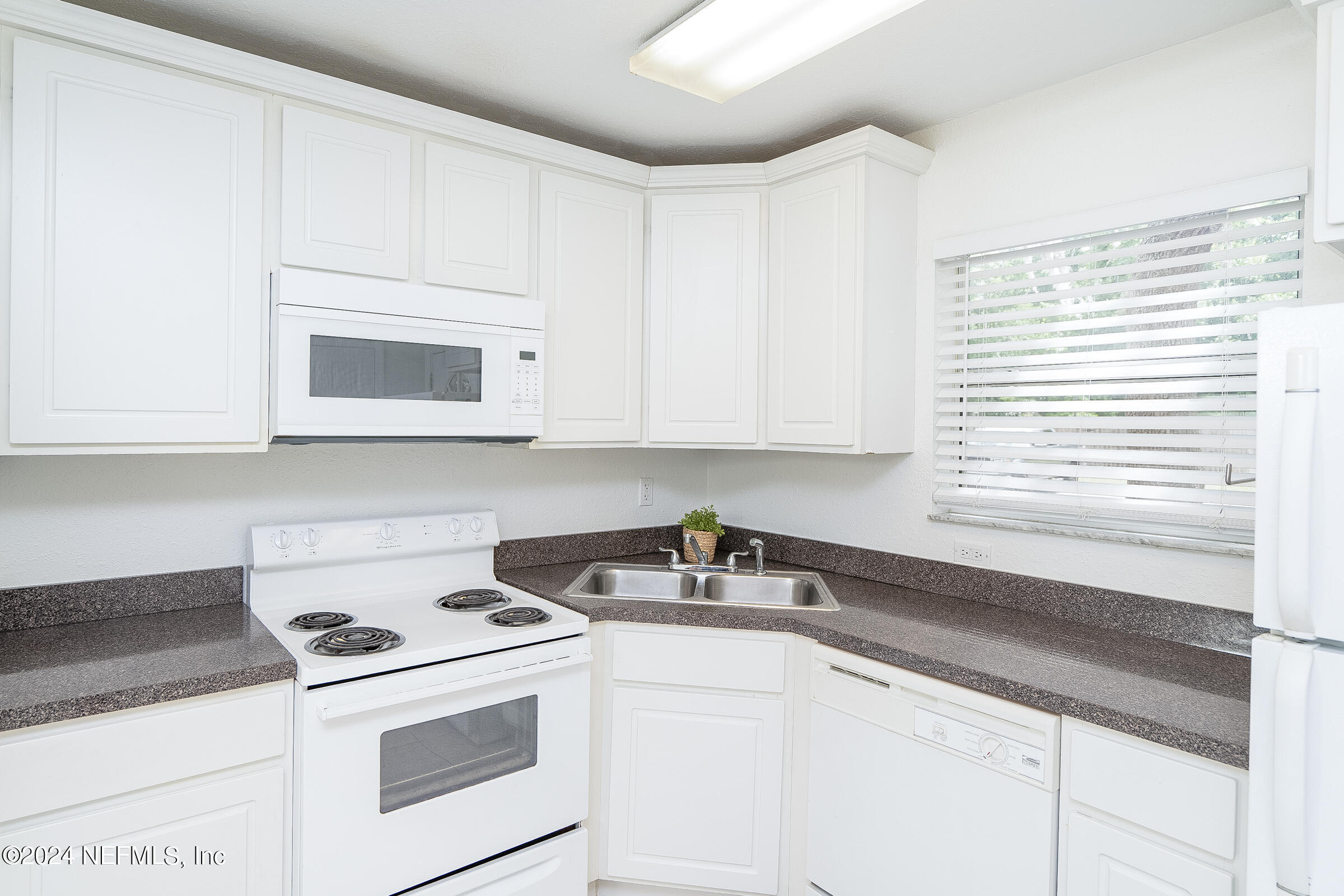 4420 Carter Road, Unit 52 St. Augustine, FL 32086 - Photo 6 of 34 a kitchen with stainless steel appliances white cabinets and a sink