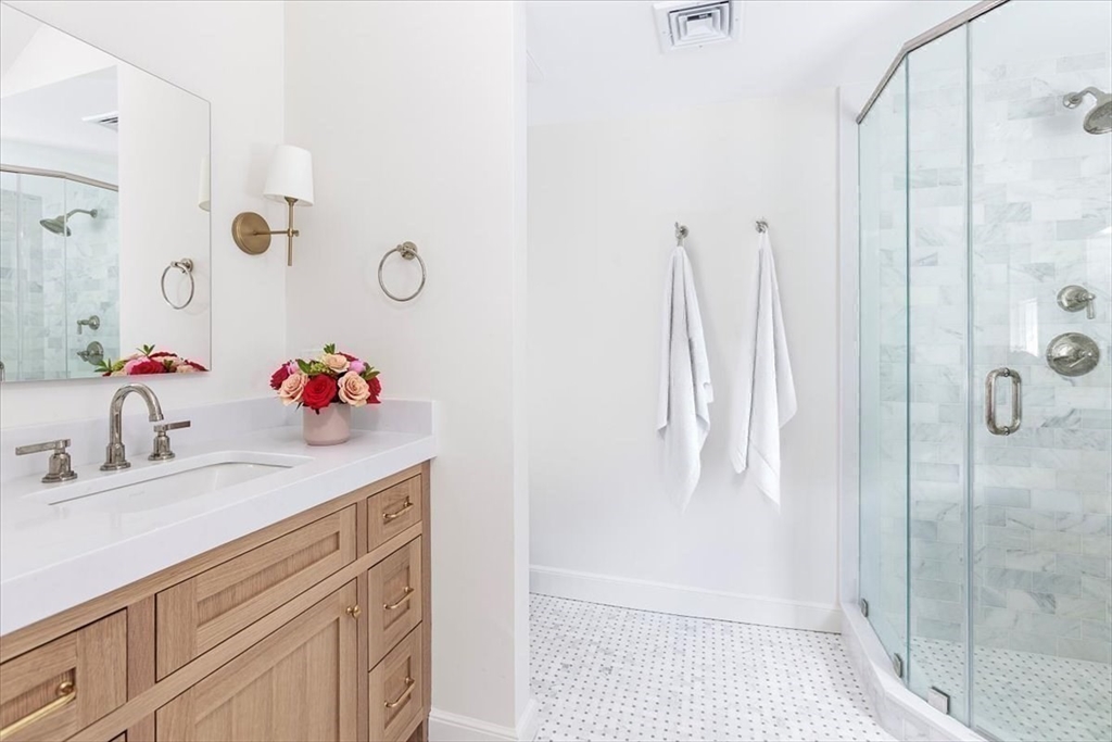12 Meadowbrook Road Weston, MA 02493 - Photo 19 of 28 a bathroom with a sink vanity and shower