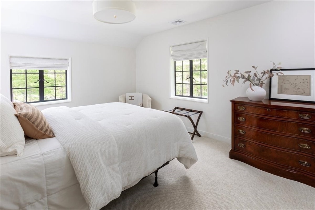 12 Meadowbrook Road Weston, MA 02493 - Photo 20 of 28 a bedroom with a bed and window