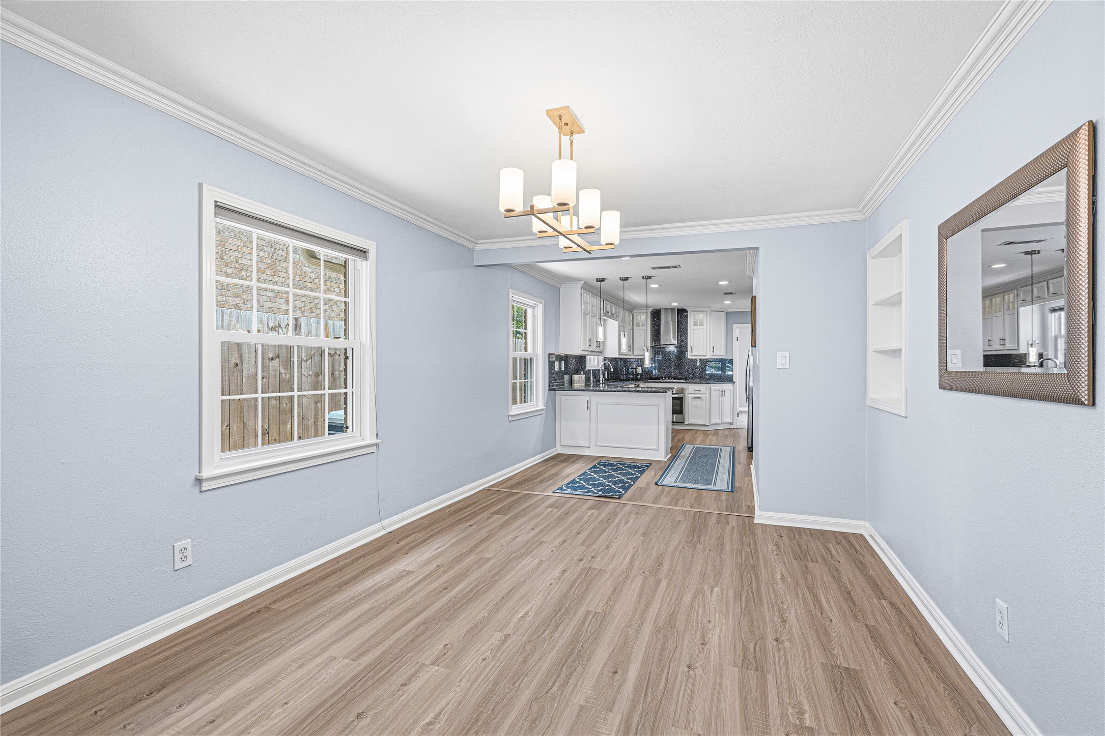 4002 Merrick Street Houston, TX 77025 - Photo 14 of 22 a view of a room with wooden floor and windows