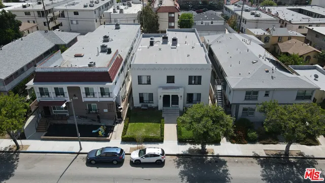 a view of multiple houses with yard patio and swimming pool