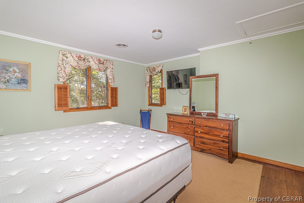 131 Ewell Road Lancaster, VA 22503 - Photo 39 of 50 a bedroom with a bed and a dresser