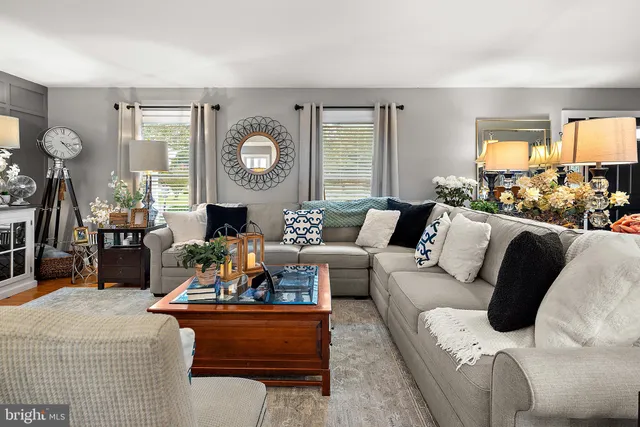 a dining room with furniture a chandelier and window