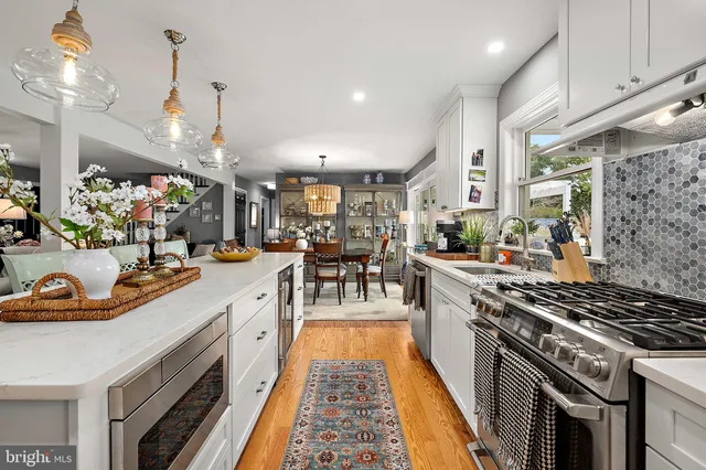 a living room with furniture and floor to ceiling windows