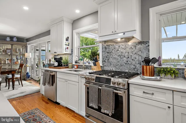 a living room with furniture and floor to ceiling windows