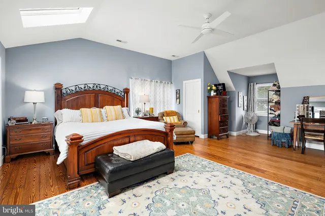 a room with gym equipment and wooden floor
