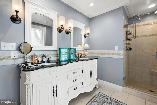 a front view of a house with a yard and potted plants