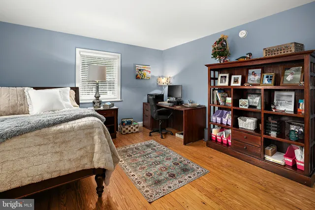a front view of a house with a garden and swimming pool