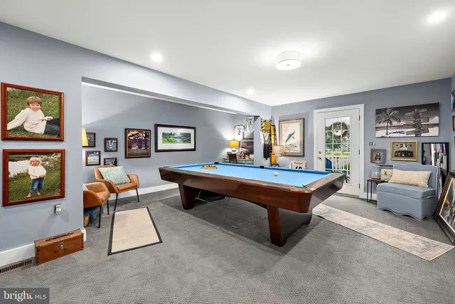 an aerial view of residential houses with outdoor space and trees