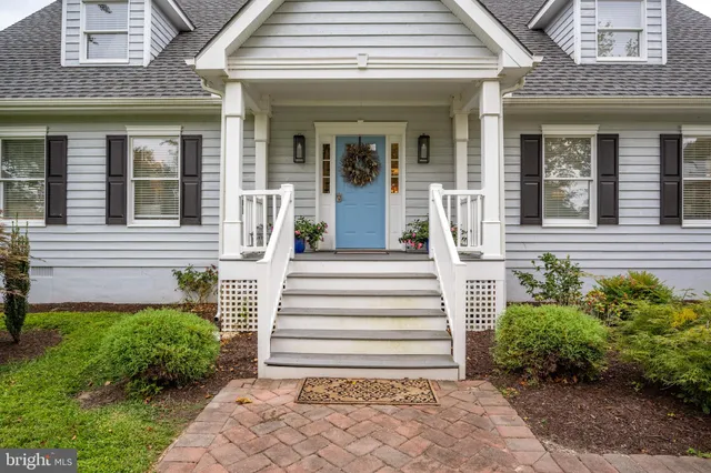 a room with lots of wooden furniture and windows