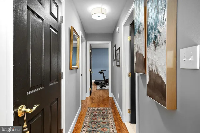 a dining room with furniture a chandelier and wooden floor