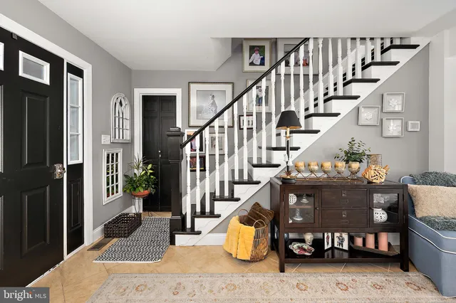 a kitchen with stainless steel appliances kitchen island granite countertop a table chairs sink and cabinets