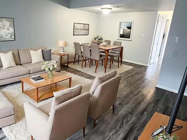 a living room with furniture and wooden floor