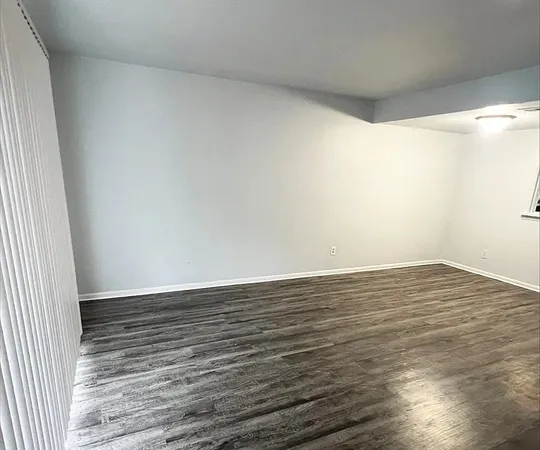 a view of an empty room and wooden floor