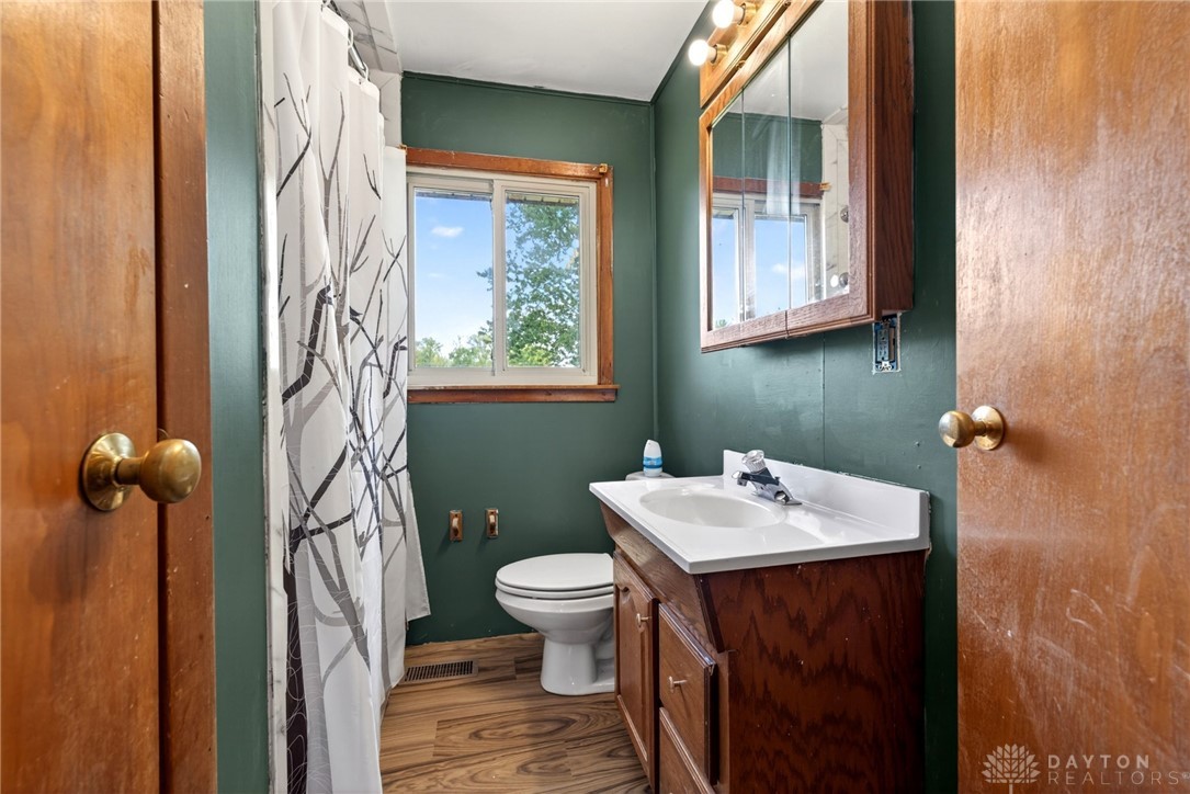 1005 Free Road New Carlisle, OH 45344 - Photo 30 of 43 This bathroom features a functional vanity and a bright window, offering everyday convenience and light.