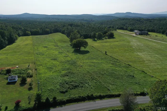 a view of a lush green hillside and a building