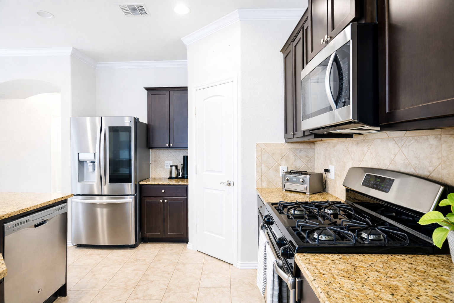 10012 Epic Knoll Drive Austin, TX 78747 - Photo 12 of 31 a kitchen with stainless steel appliances granite countertop a stove a refrigerator and a microwave
