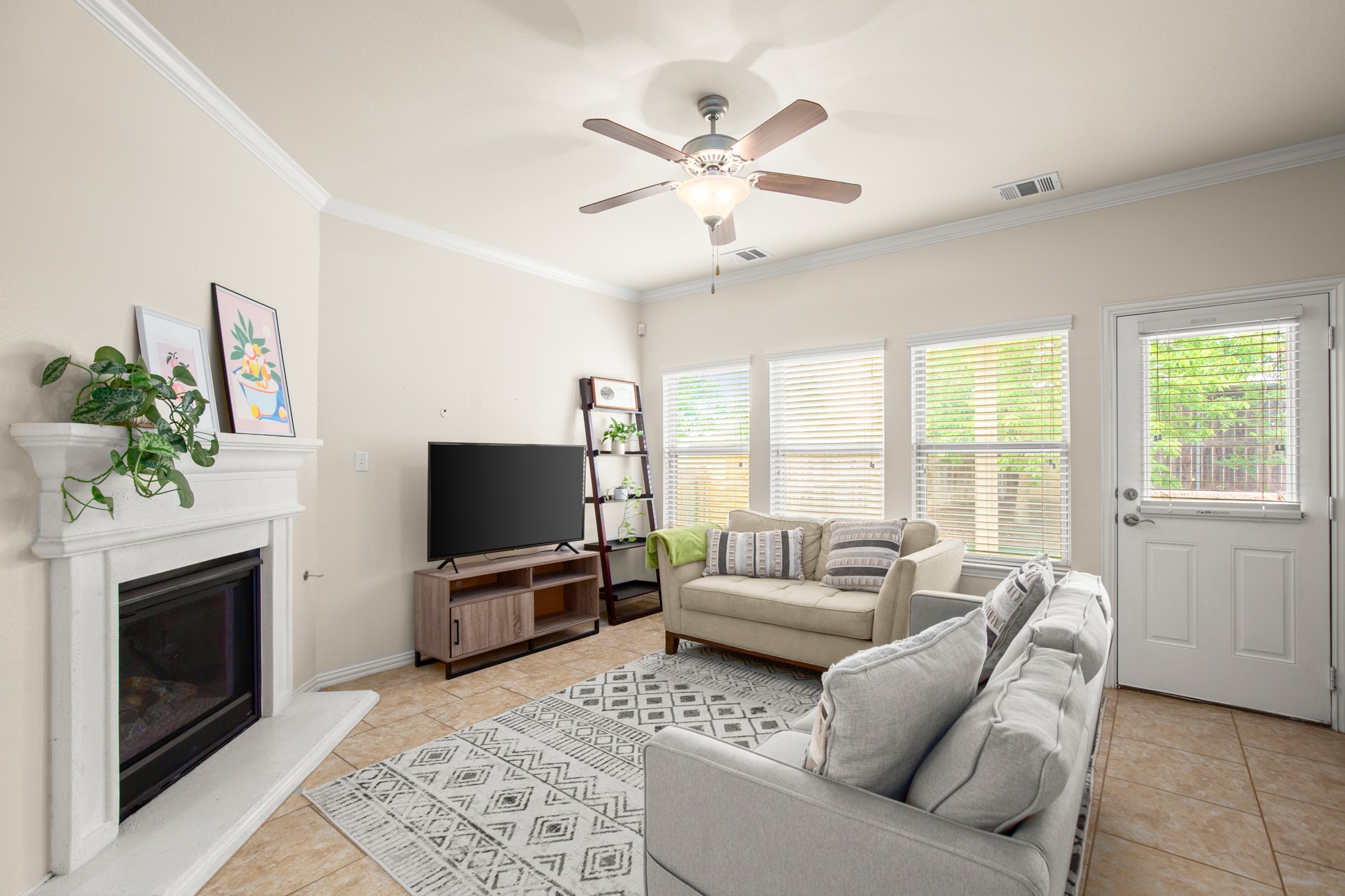 10012 Epic Knoll Drive Austin, TX 78747 - Photo 5 of 31 a living room with furniture a flat screen tv and a fireplace