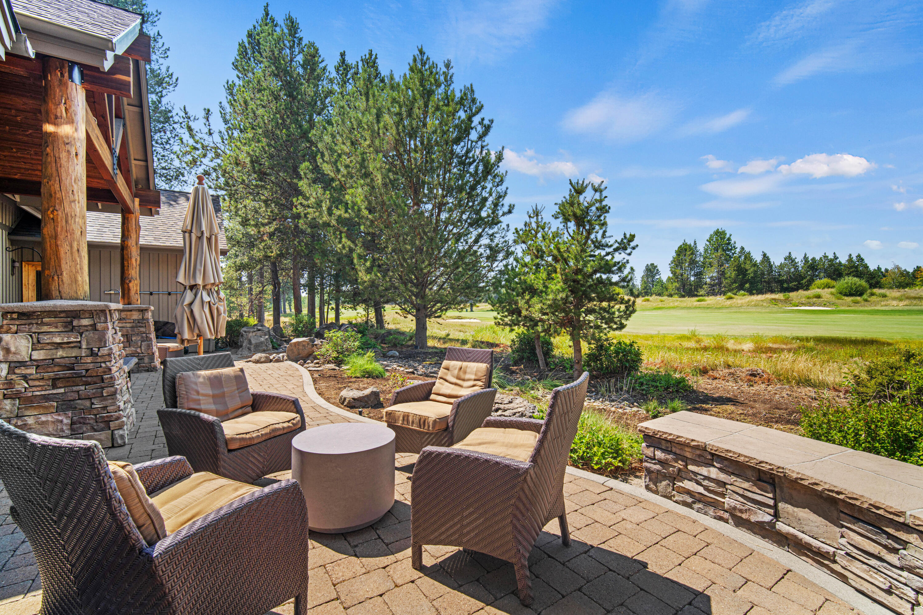 56689 Dancing Rock Loop Bend, OR 97707 - Photo 41 of 51 a view of a patio with couches table and chairs and potted plants