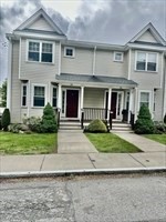26 Bacon Street, Unit 26 Watertown, MA 02472 - Photo 12 of 12 a front view of a house with a yard and a garage