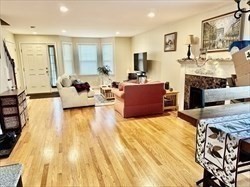 26 Bacon Street, Unit 26 Watertown, MA 02472 - Photo 4 of 12 a large bedroom with a large bed and a couch