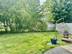 26 Bacon Street, Unit 26 Watertown, MA 02472 - Photo 7 of 12 a view of a backyard with potted plants