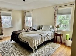 26 Bacon Street, Unit 26 Watertown, MA 02472 - Photo 8 of 12 a bedroom with a bed and wooden floor