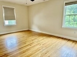 26 Bacon Street, Unit 26 Watertown, MA 02472 - Photo 10 of 12 a view of an empty room with wooden floor and a window