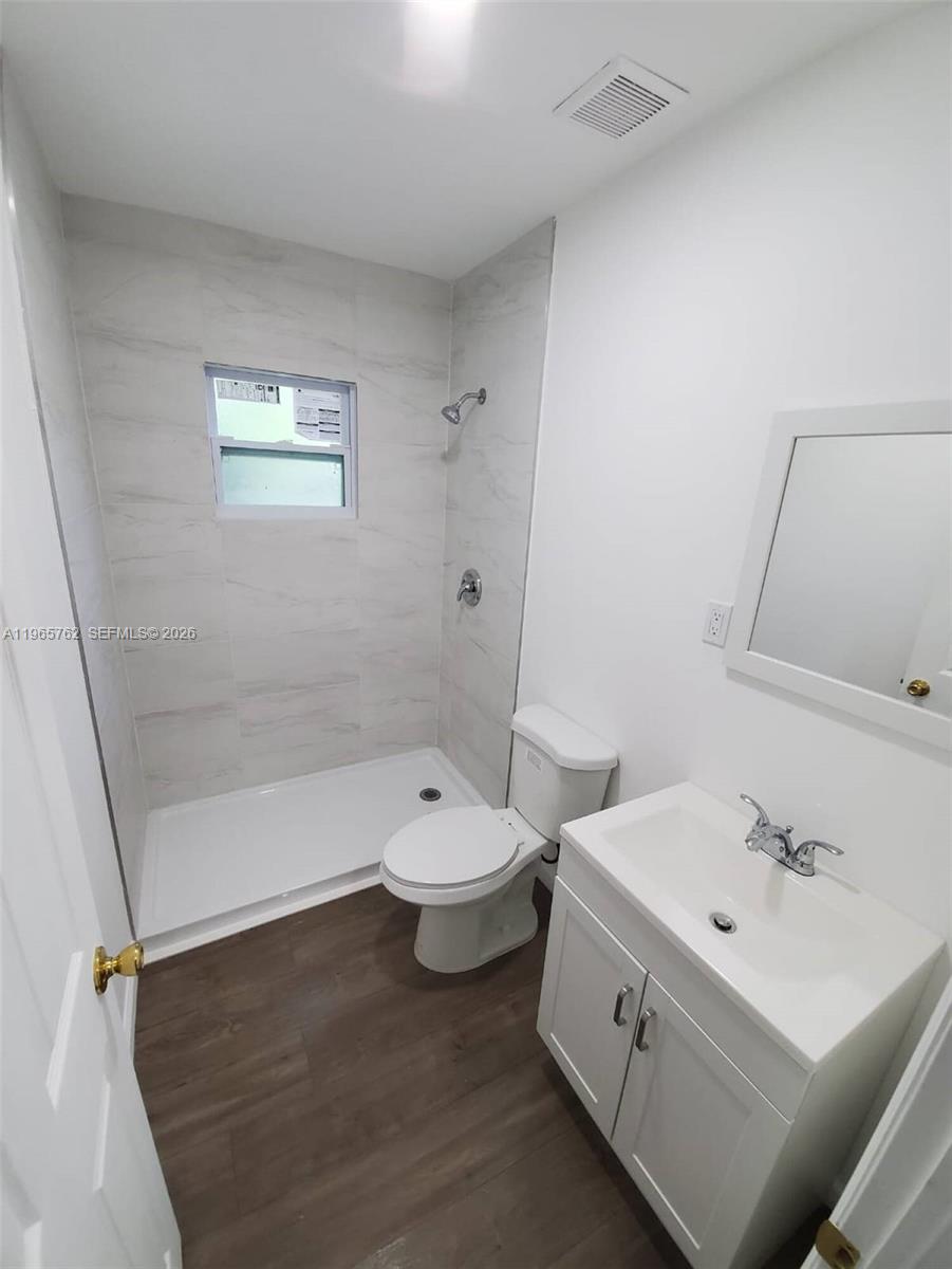2425 Northwest 28th Street Miami, FL 33142 - Photo 14 of 18 a bathroom with a double vanity sink toilet and a bathtub