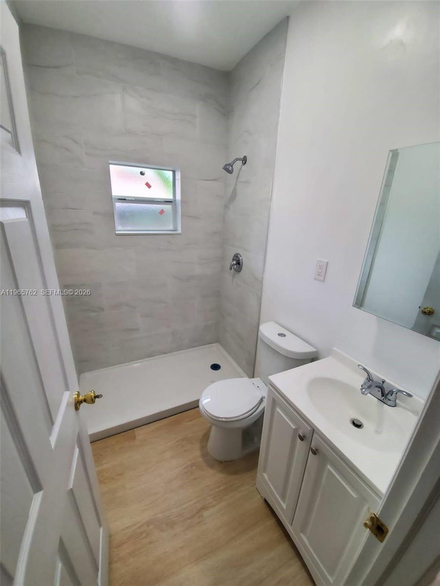 2425 Northwest 28th Street Miami, FL 33142 - Photo 9 of 18 a bathroom with a sink a toilet and shower