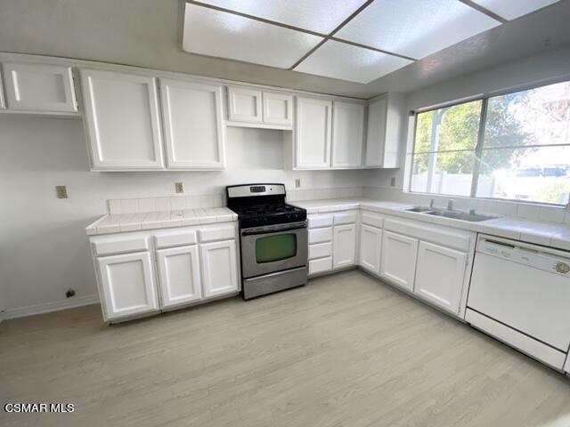 1842 Rory Lane, Unit 7 Simi Valley, CA 93063 - Photo 8 of 19 a kitchen with white cabinets sink and appliances