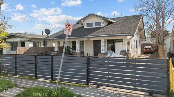 a view of a white house with large windows