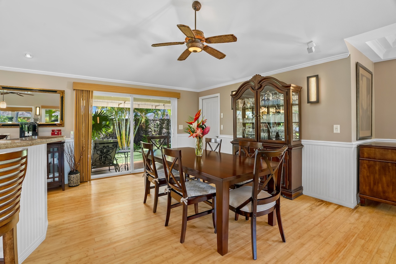 2889 Milo Hae Loop Koloa, HI 96756 - Photo 11 of 27 a dining room with furniture a chandelier and wooden floor
