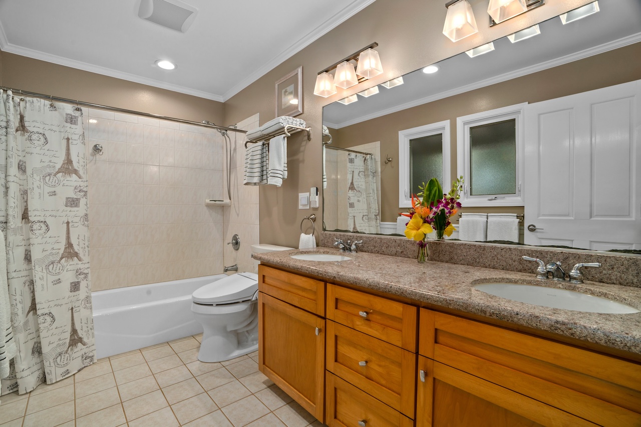 2889 Milo Hae Loop Koloa, HI 96756 - Photo 18 of 27 a bathroom with a granite countertop sink a toilet a mirror a bathtub and shower