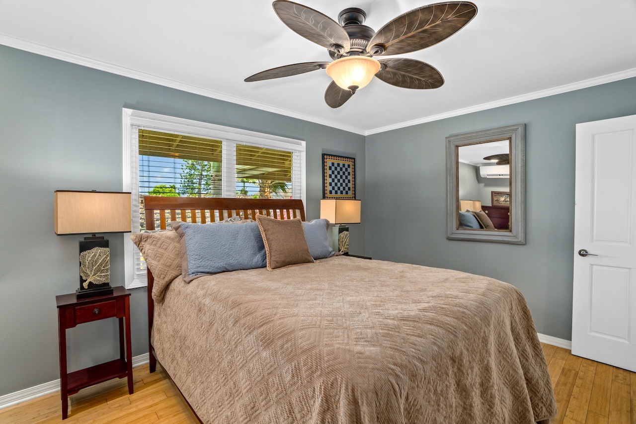 2889 Milo Hae Loop Koloa, HI 96756 - Photo 21 of 27 a bedroom with a large bed and a lamp