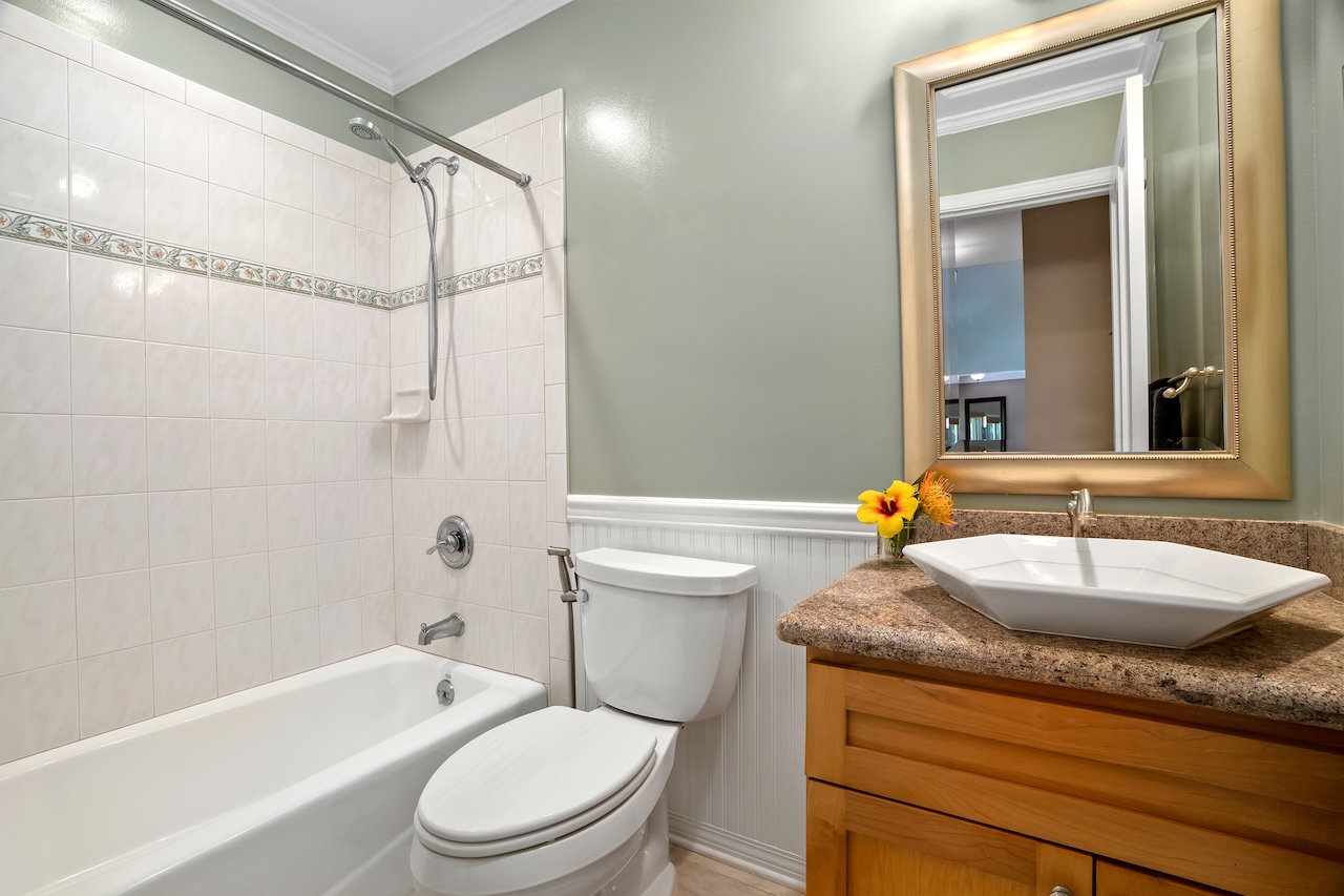 2889 Milo Hae Loop Koloa, HI 96756 - Photo 22 of 27 a bathroom with a granite countertop sink toilet mirror and bathtub