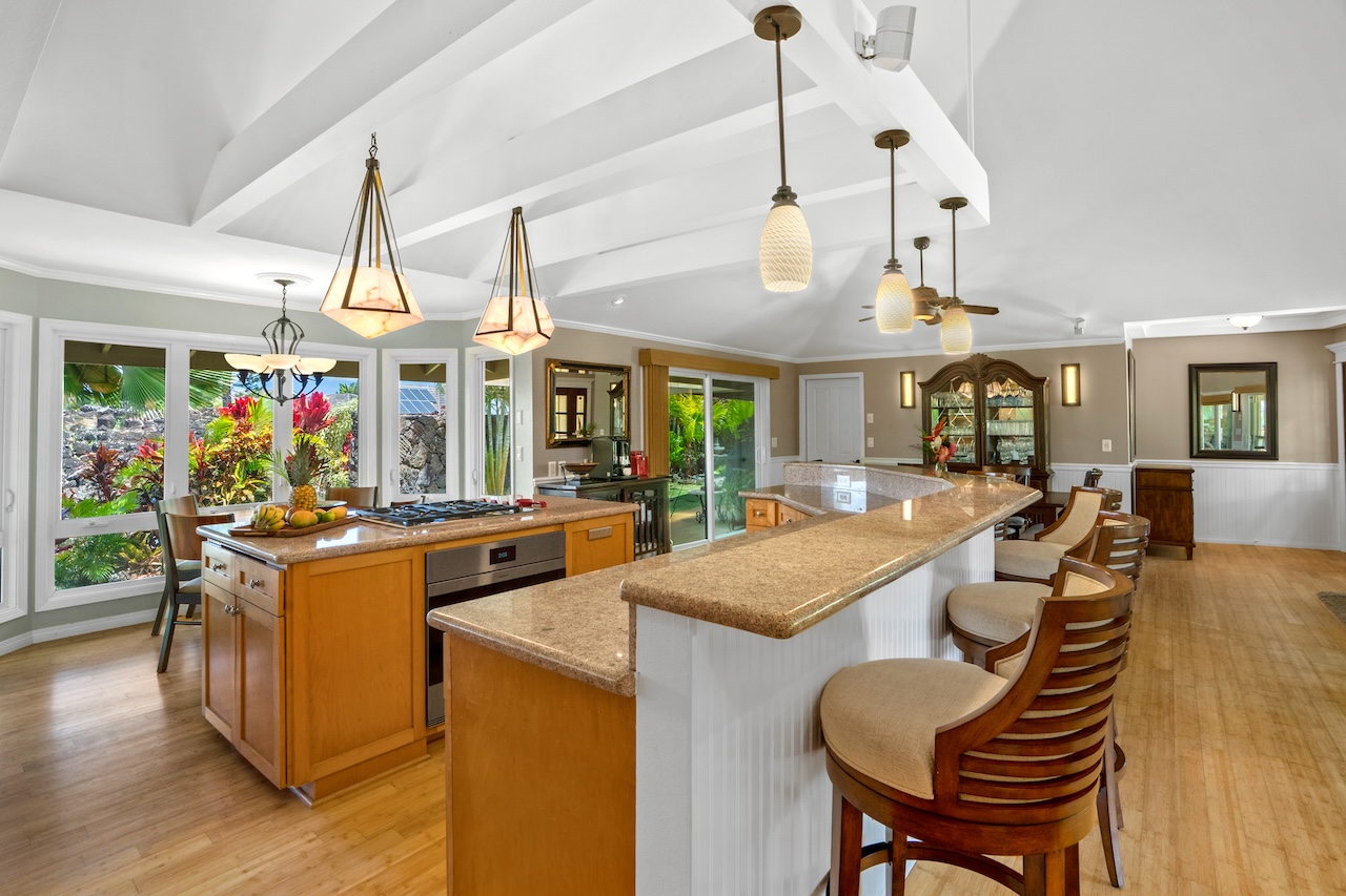 2889 Milo Hae Loop Koloa, HI 96756 - Photo 7 of 27 an open kitchen with wooden floor and stainless steel appliances