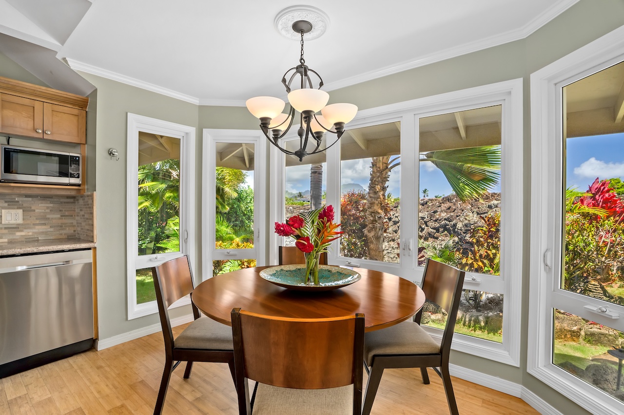 2889 Milo Hae Loop Koloa, HI 96756 - Photo 8 of 27 a dining room with furniture a large window and a chandelier